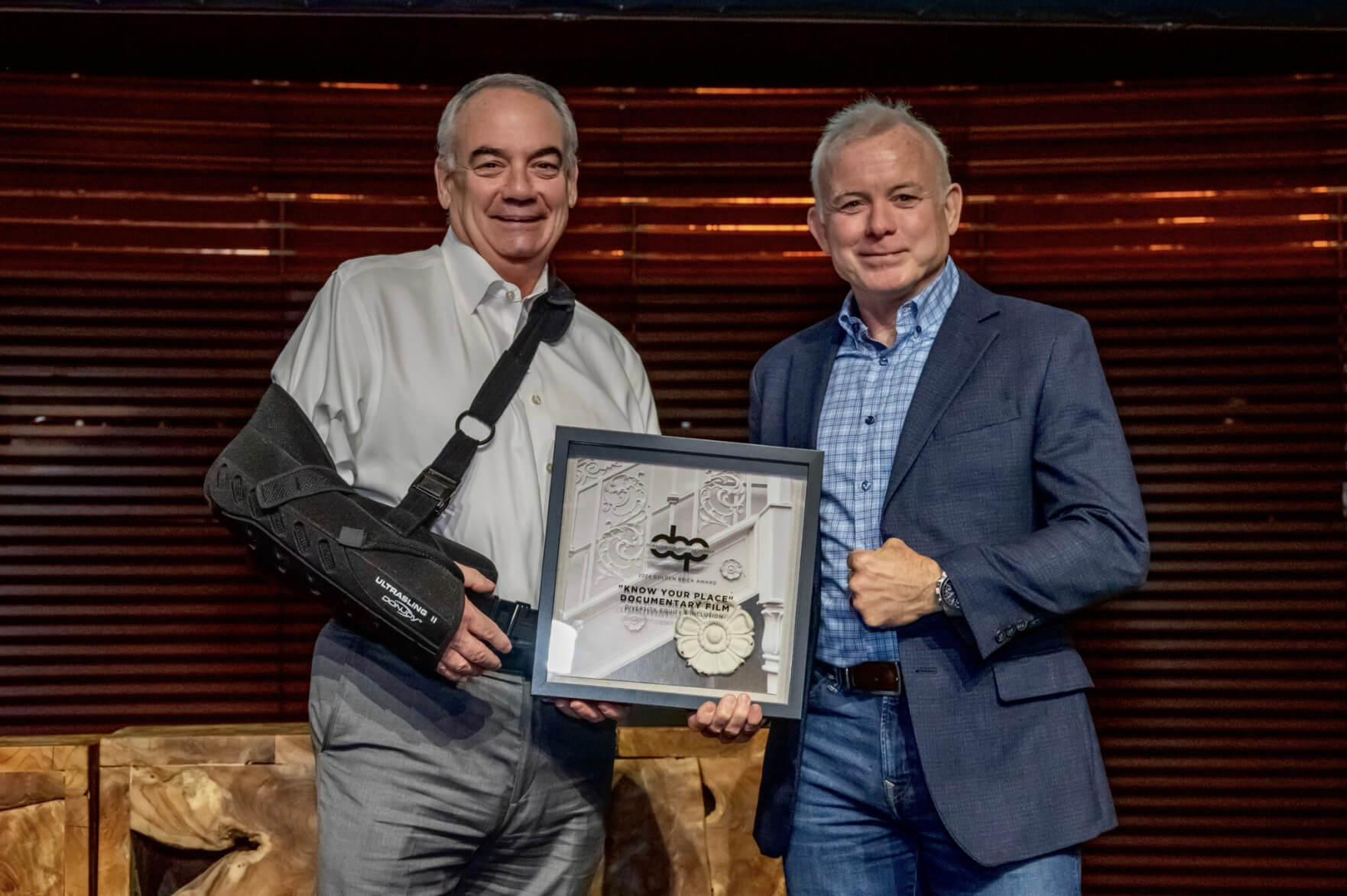 Jeff Hayward (left), president and CEO of Heart of Florida United Way, and Jim Hobart, owner of Macbeth Studio, accept the Diversity, Equity &amp; Inclusion award for the documentary film “Know Your Place,” which is available to watch on the United Way’s YouTube Channel.
(BRION PRICE/COURTESY OF DOWNTOWN ORLANDO PARTNERSHIP)